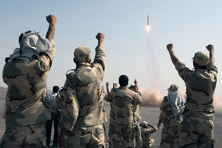 Picture desk live: Members of the Iranian Revolutionary Guard after launching a missile