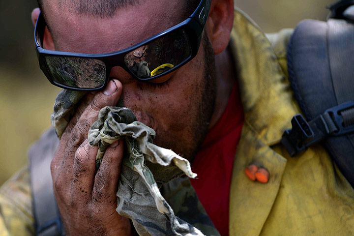 Picture desk live:  A firefighter wipes his face while tackling the Waldo Canyon wildfire