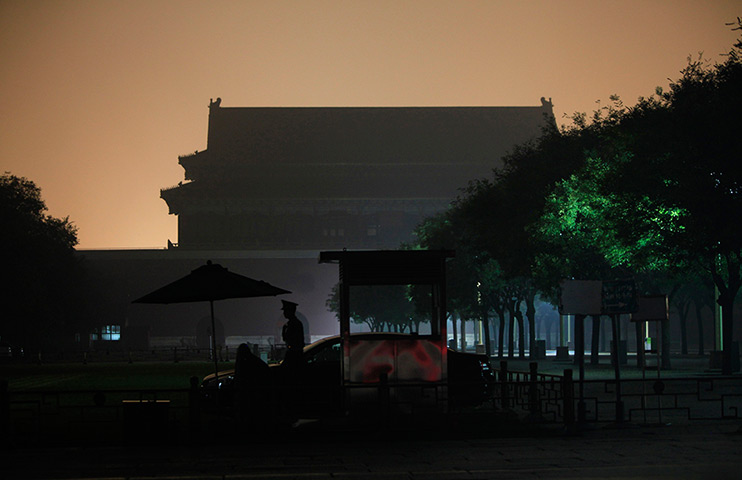 24 hours: Beijing, China: A paramilitary police officer walks at the Forbidden City 