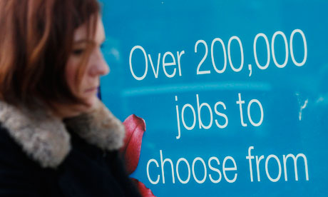 A woman passes a recruitment centre in London