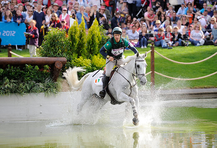 equestrian 5: Mark Kyle of Ireland on Coolio in the water after jumping fence 17