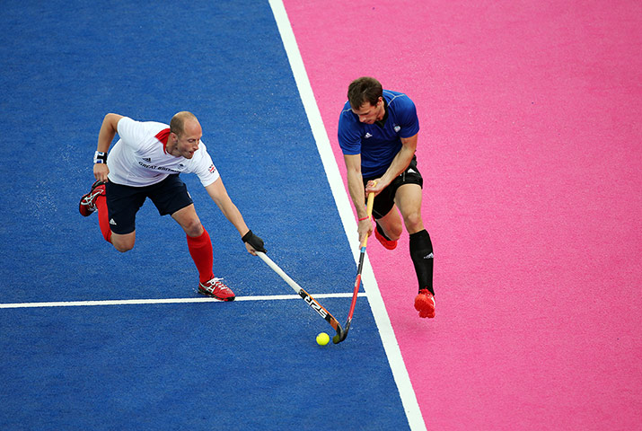Hockey: Ben Hawes of Team GB attempts to put a stop to a marouding Argentine