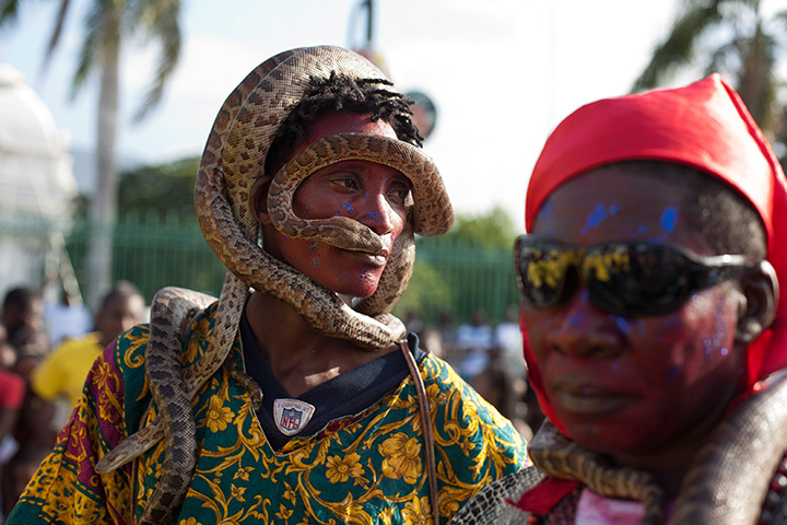 Carnival of flowers: A man with a snake on his head attends