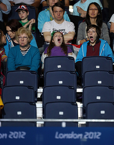 Olympic empty seats : Children yawn behind rows of empty seats