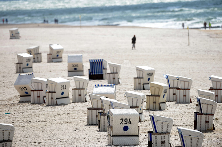 24 hours: Kampen, Germany: People walk on a beach on the North Sea island of Sylt