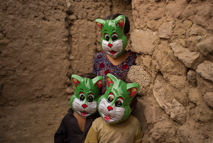 24 hours: Islamabad, Pakistan: Children whose families fled fighting, play in masks