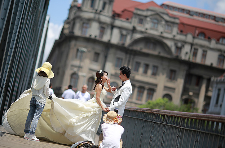 24 hours: Shanghai, China: A newly wed couple poses for wedding photo shoot