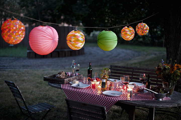 Brita - Table decorations: Dinner party table outdoors with candles and paper lanterns