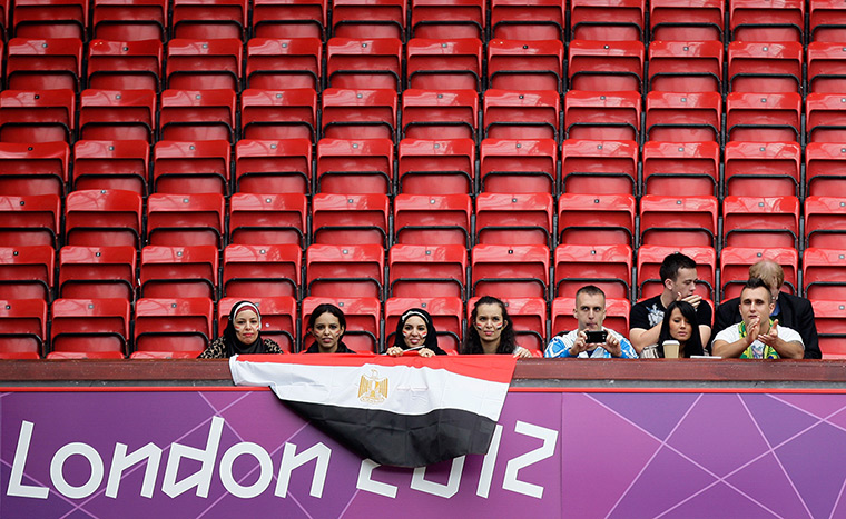 empty seats update : Spectators sit amongst empty seats at Old Trafford Stadium in Manchester