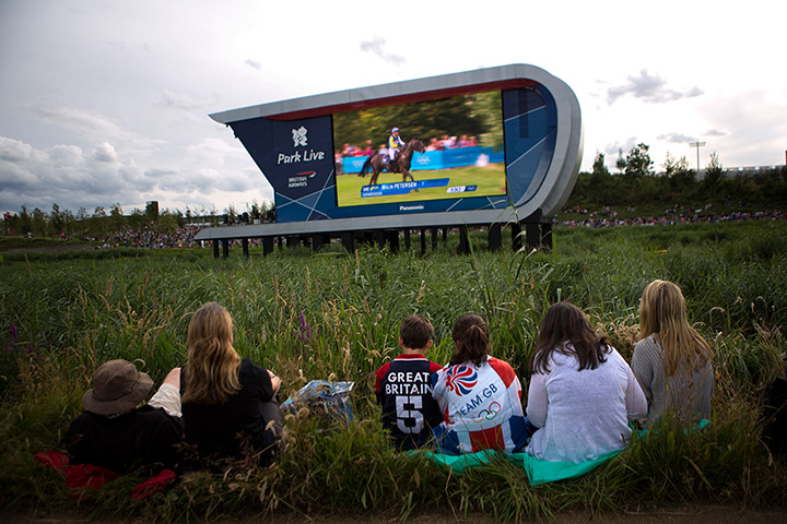 Quiet London: Spectators watch on a big screen television at the Olympic Park