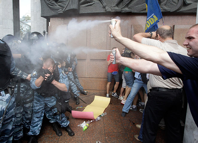 Picture desk live: Protestors spray riot police with tear gas at a demonstration in Kiev