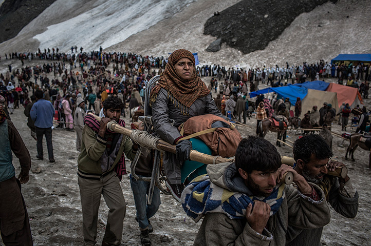 FTA: Daniel Berehulak: A Hindu pilgrim is carried on a palanquin over a glacier