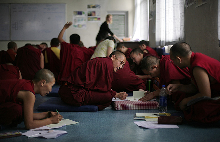 24 hours in pictures: Tibetan Buddhist monks and nuns work during a class