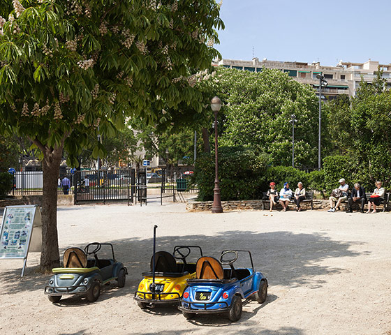 Rencontres Arles 2012: Childrens' cars parked in sandpit in sleepy French park