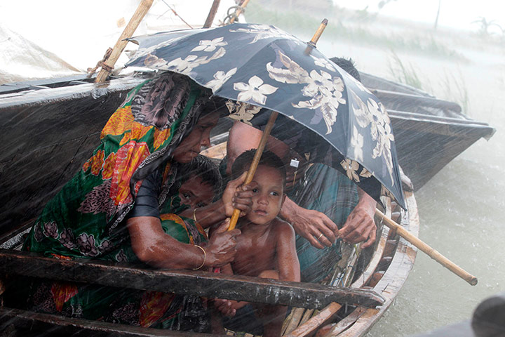 Picture desk live: People shelter from heavy rains at a flooded village in Bangladesh