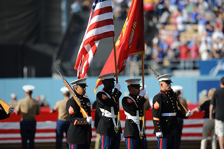 Independence Day: Armed forces members carry flags during the national anthem
