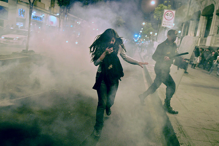 Picture Desk Live: A protester runs from tear gas on July 4