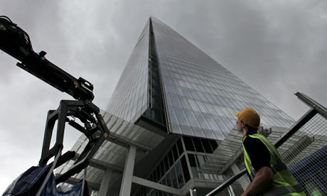 A worker looks up at the Shard