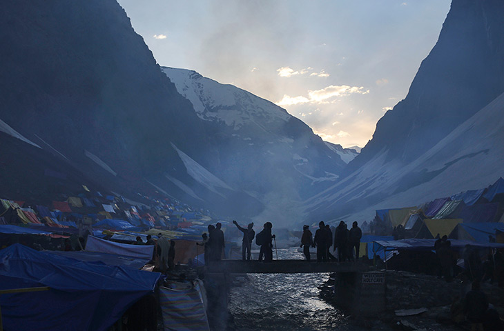 24 hours: Srinagar, India: Hindu pilgrims cross a bridge en route to Amarnath cave