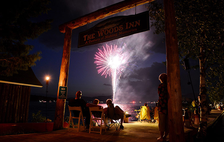 New York fireworks: Fireworks watchers on a dock in Inlet, New York