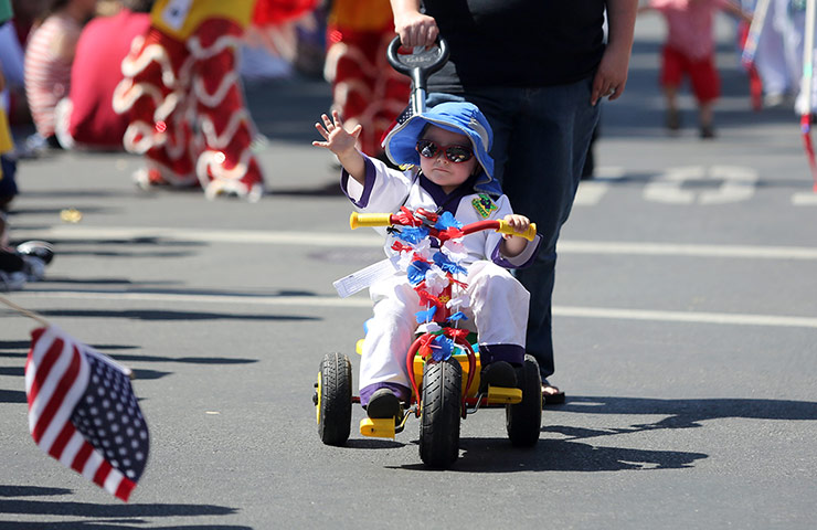 Fourth July 2012: William Jackson, 3, waves to the crowd during the Fourth of July Parade