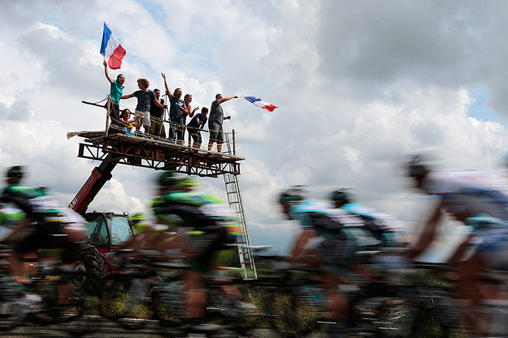 Picture Desk Live: Fans wave a French flag as the Tour de France pass
