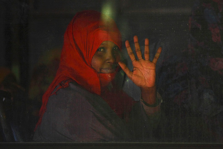 24 hours in pictures: An immigrant waves from a police bus 