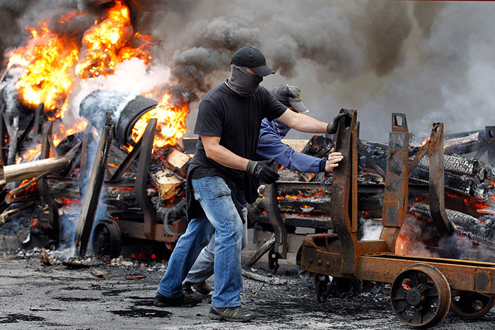 Picture Desk Live: Spanish miners burn tires to cut a road