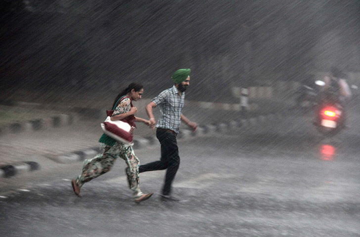 Picture desk live: Commuters run for cover during monsoon rain
