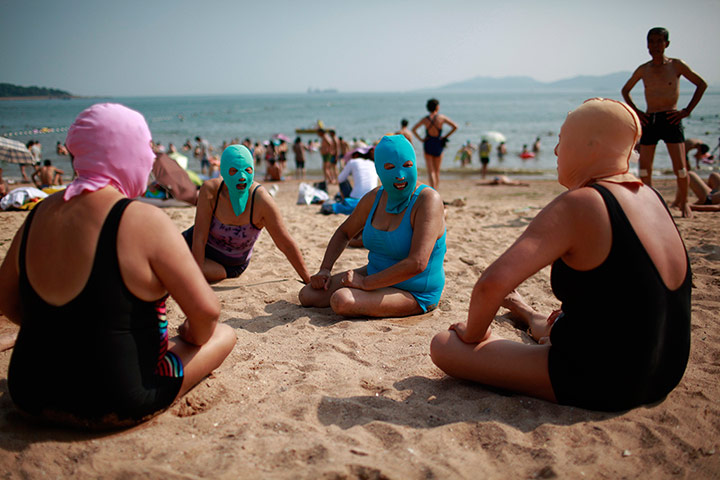 Picture desk live: Women, wearing nylon masks as they sunbathe