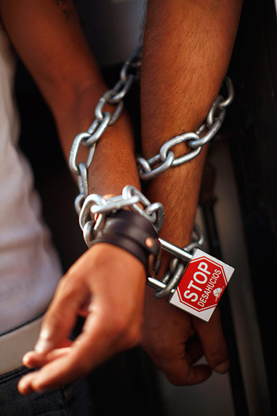 24 Hours: Protesters chain themselves to the door of a residential building in Malaga