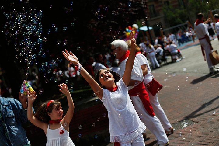 Pamplona: Girls play with soap bubbles during the San Fermin festival in Pamplona