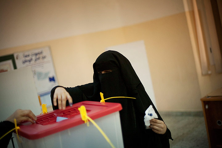 Libya Elections: A Libyan woman votes at a polling station in the old city of Tripoli