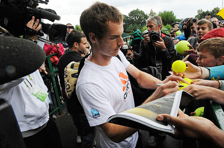 Wimbledon day 12: Andy Murray signs autographs after training