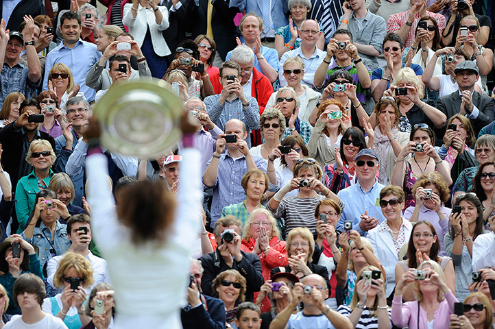 Wimbledon day 12: Serena Williams shows off the trophy to the crowd