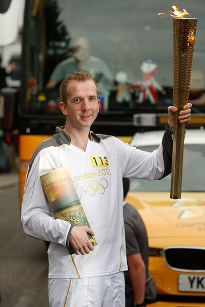 Olympic flame: Torchbearer 113 Mark Reynolds 
