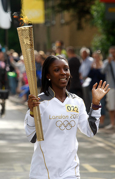 Olympic flame: Torchbearer 022 Hannah Agyeman-Prempeh carries the Olympic flame