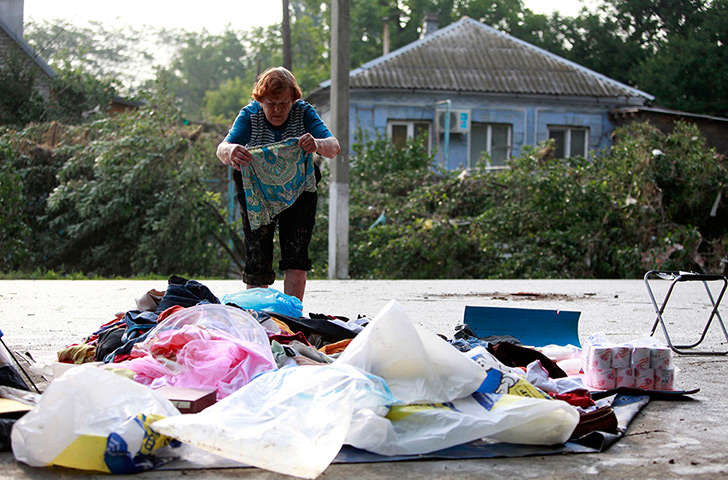 Russia Floods: A local resident lays out her belongings on the ground in Krymsk
