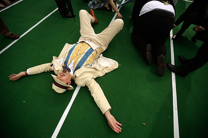 Chap Olympiad 2012: A competitor collapses at the finish line of the Ironing Board Surfing race