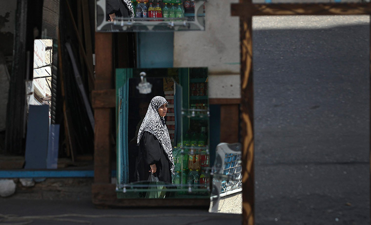  24 hours: Jabaliya, Gaza Strip: A Palestinian woman is reflected in mirrors for sale