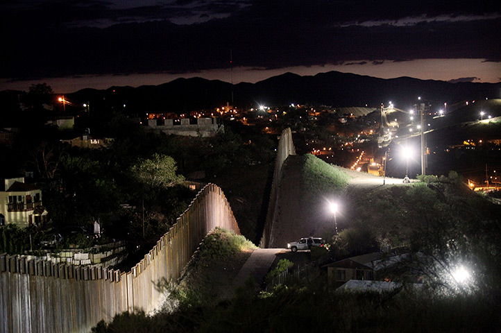  24 hours: Nogales, Arizona: The border wall is illuminated at night 