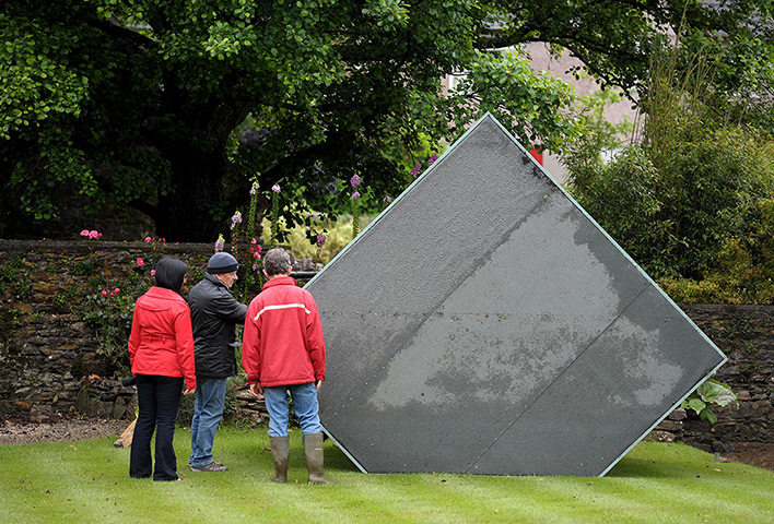  24 hours: Yealmpton, England: A shed lies overturned in flood water 