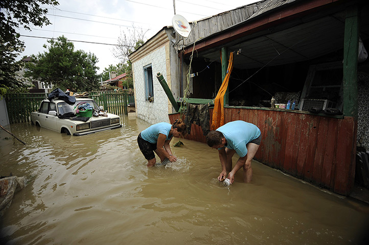 Russia floods: Local people work amidst the debris of a house in Krymsk