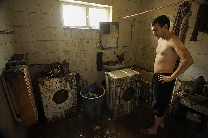 Russia floods: A local man inspects his flooded house in Krymsk 