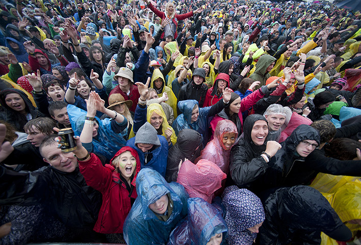 Summer rain: Festival goers endure the rain at the main stage during T In The Park