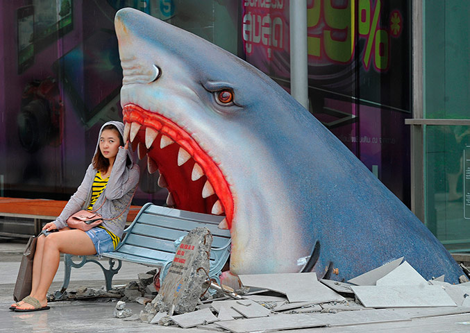 Picture Desk Live: A foreign tourist sits next to a large a