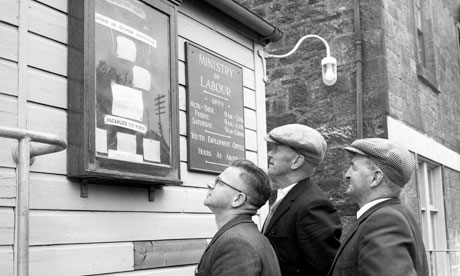 Three unemployed miners looking at job adverts on a noticeboard
