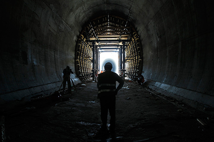 24 hours: Labourers stand inside a tunnel at the site of high speed rail 