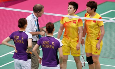 Olympic referee Torsten Berg warns players from China and South Korea during their badminton match