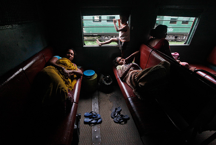India blackout ends: Passengers rest inside a train while waiting for electricity to be restored